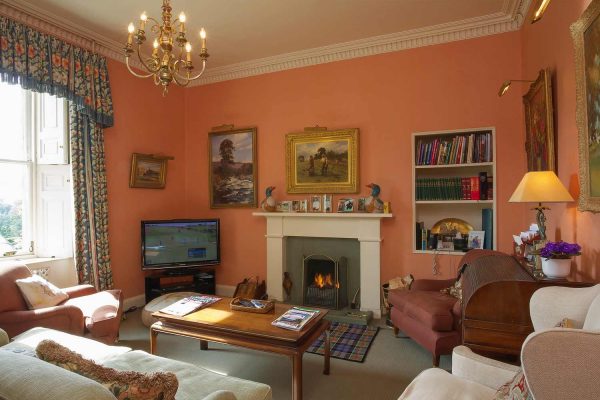 A colour image of the study with roaring fire at Edradynate Country House and Sporting Estate Scotland. Edradynate is available for rent, shoot days, fishing and family holidays on a catered or self catered basis.