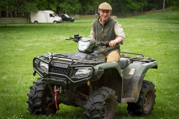 A colour image of Ciaran Woodman- Robinson Underkeeper riding a quad bike at the Edradynate May 2017 clay pigeon shoot day - Edradynate Estate, Perthshire - Luxury Country House and Sporting Estate for Rent in Scotland