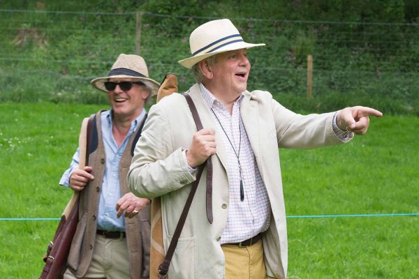 A colour image of gentlemen in panama hats laughing and enjoying clay pigeon shooting at the Edradynate May 2017 shoot day - Edradynate Estate, Perthshire - Luxury Country House and Sporting Estate for Rent in Scotland