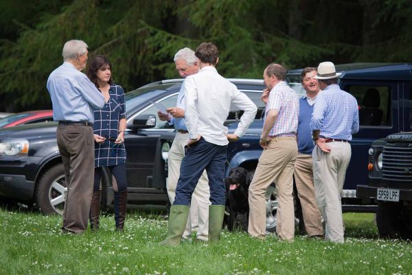 A colour image of Michael Campbell stood with guests socialising stood by 4 x 4 vehicles at the Edradynate May 2017 clay pigeon shoot day - Edradynate Estate, Perthshire - Luxury Country House and Sporting Estate for Rent in Scotland