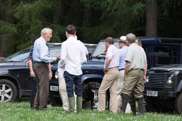 A colour image of guests socialising stood by 4 x 4 vehicles at the Edradynate May 2017 clay pigeon shoot day - Edradynate Estate, Perthshire - Luxury Country House and Sporting Estate for Rent in Scotland