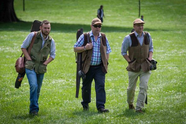 A colour image of guests walking and carrying guns at the Edradynate May 2017 clay pigeon shoot day - Edradynate Estate, Perthshire - Luxury Country House and Sporting Estate for Rent in Scotland