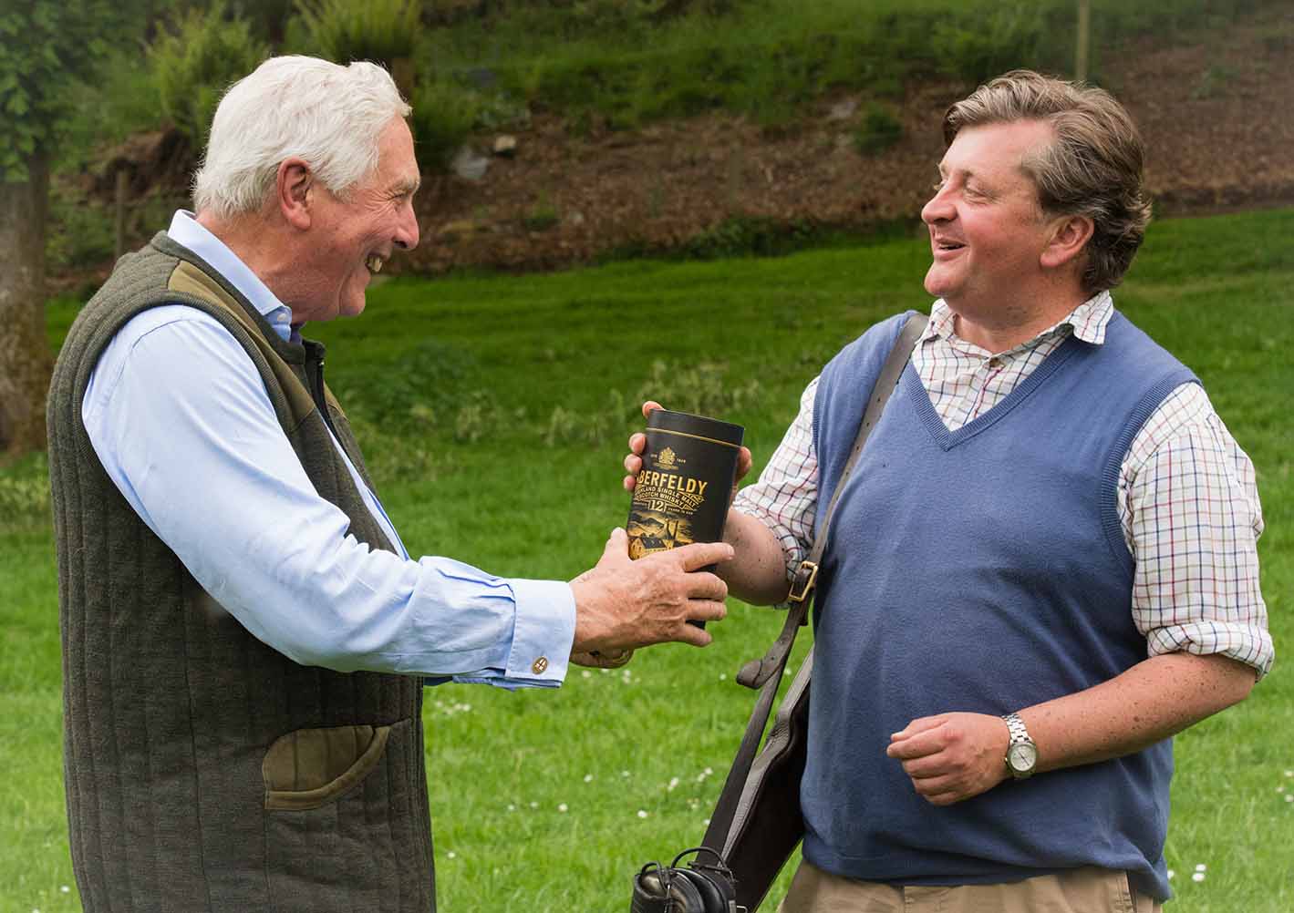 An image of Michael Campbell presenting Patrick Stuart-Fotheringham with a bottle of Aberfeldy as winner of the Charity Pool Shoot at Edradyante clay pigeon shoot day May 2017 - Edradynate Estate, Perthshire - Luxury Country House and Sporting Estate for Rent in Scotland